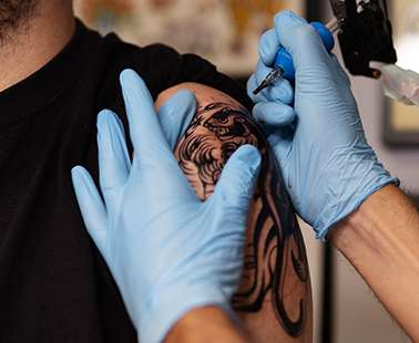 2 tattoo artists guide us into the modern world of tattooing