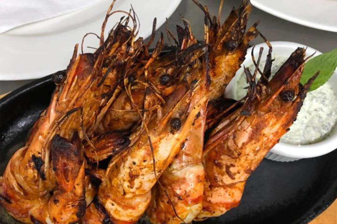 Enjoy delicious food in front of one of the most beautiful coasts of the Mediterranean